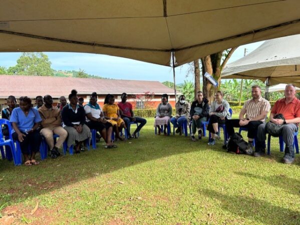 Goliath Health Centre staff and Canadian volunteers meeting under the tent